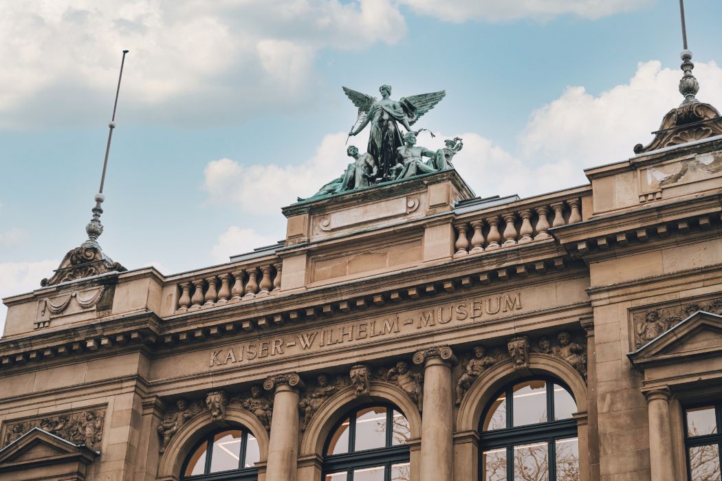 The Kaiser Wilhelm Museum is adorned with the 1.7-ton bronze group Genius of the Arts