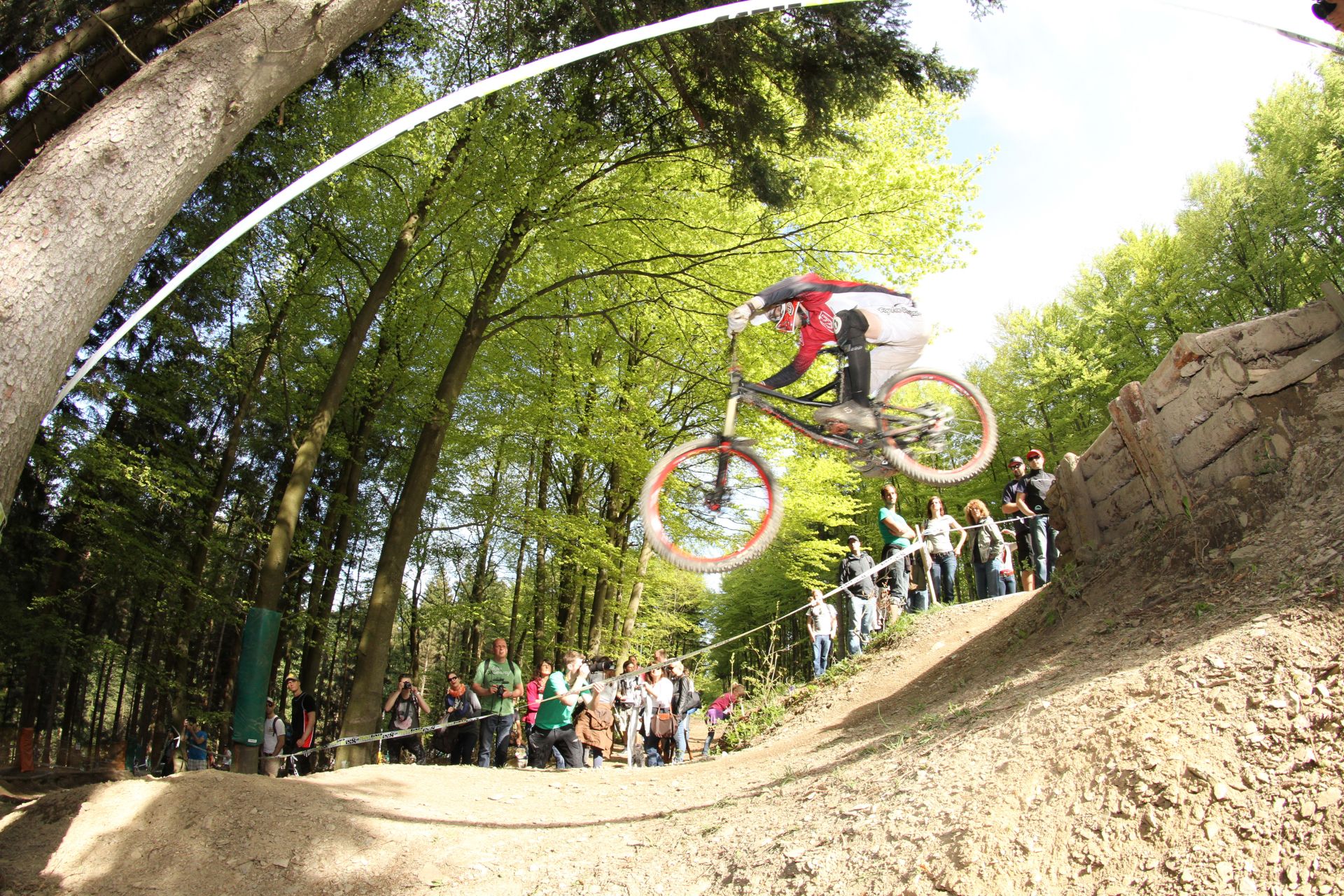 Sports fans admire the riding skills of professional cyclists from the roadside at the iXS Dirt Masters