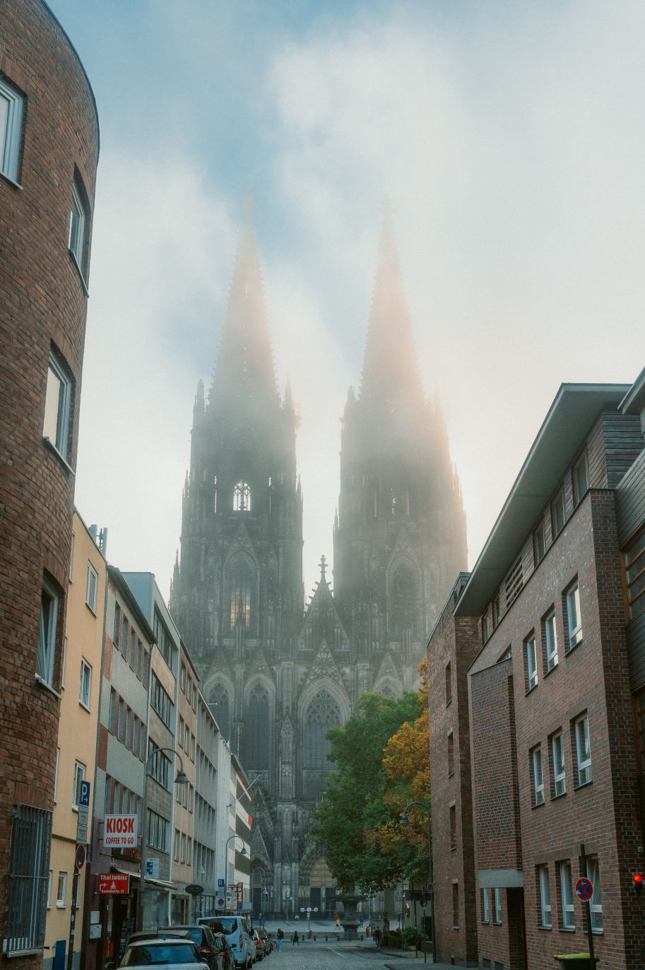 Cologne Cathedral towers like a giant between the canyons of houses