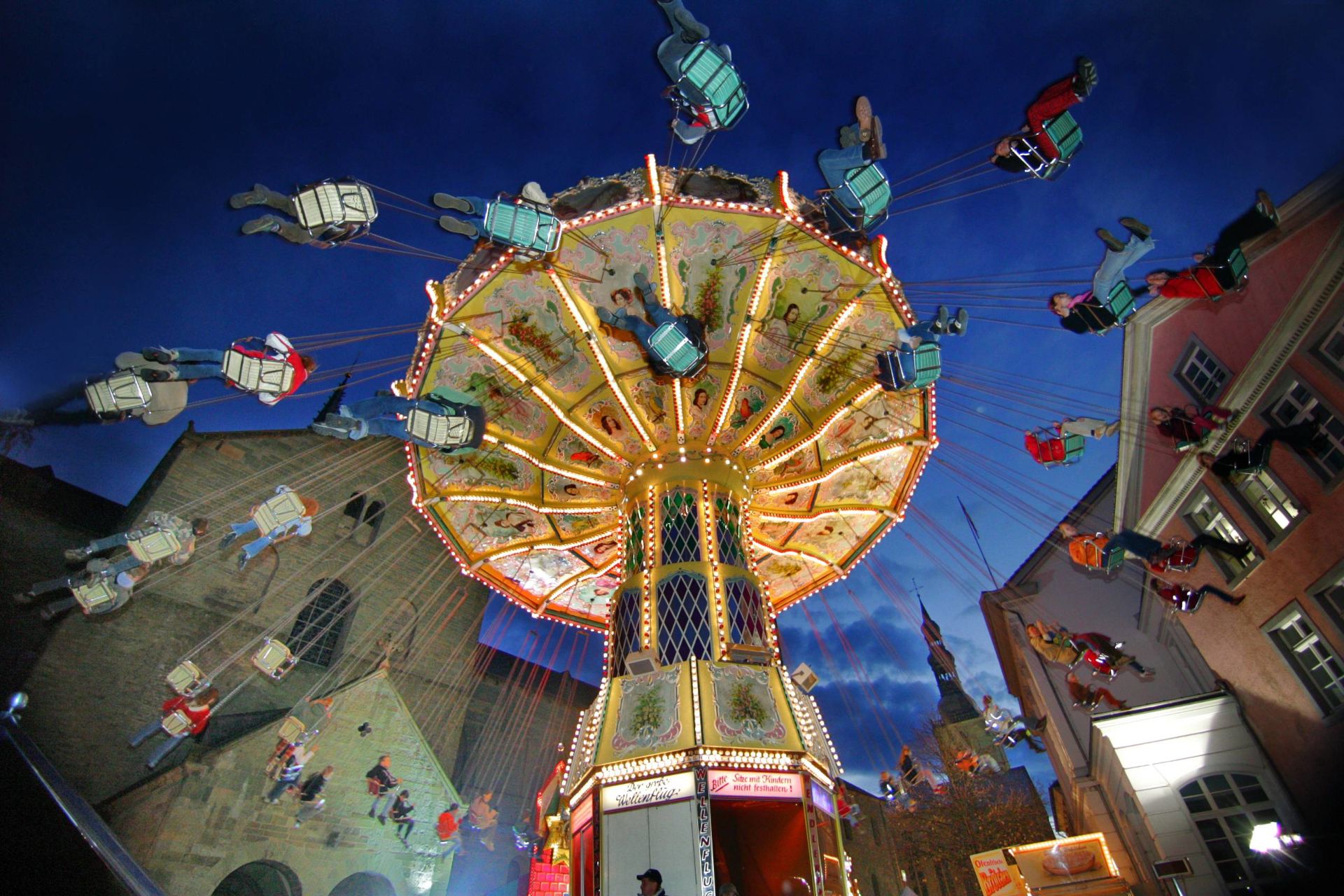 Young and old alike take a spin on a chain carousel at the Soest All Saints' Fair