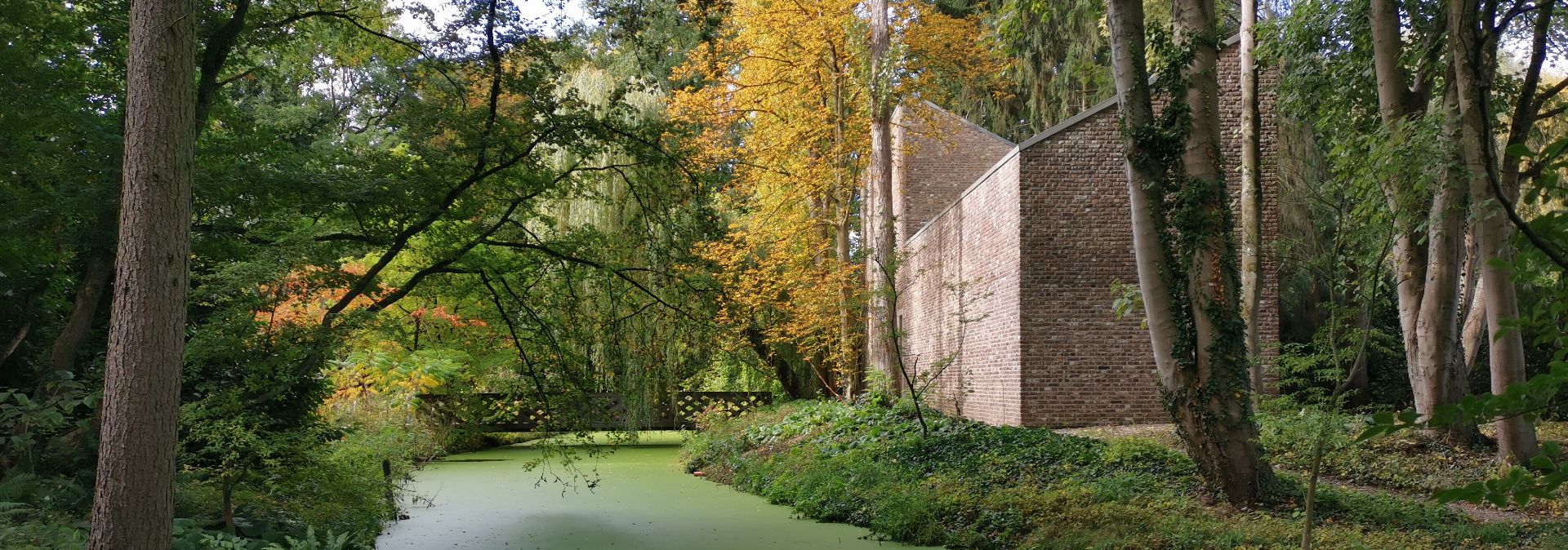 One of ten accessible sculptures by the sculptor Erwin Heerich is surrounded by a watercourse in the landscape