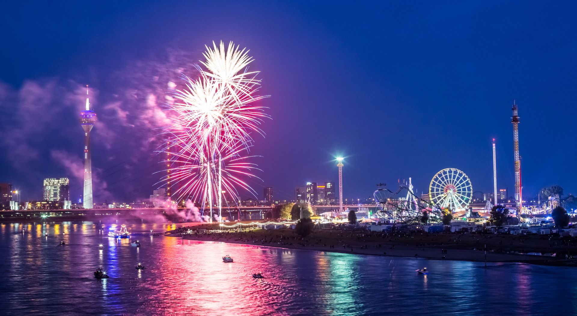 Rockets light up the banks of the Rhine. The fireworks are one of the highlights of the Rhine Fair in Düsseldorf every year