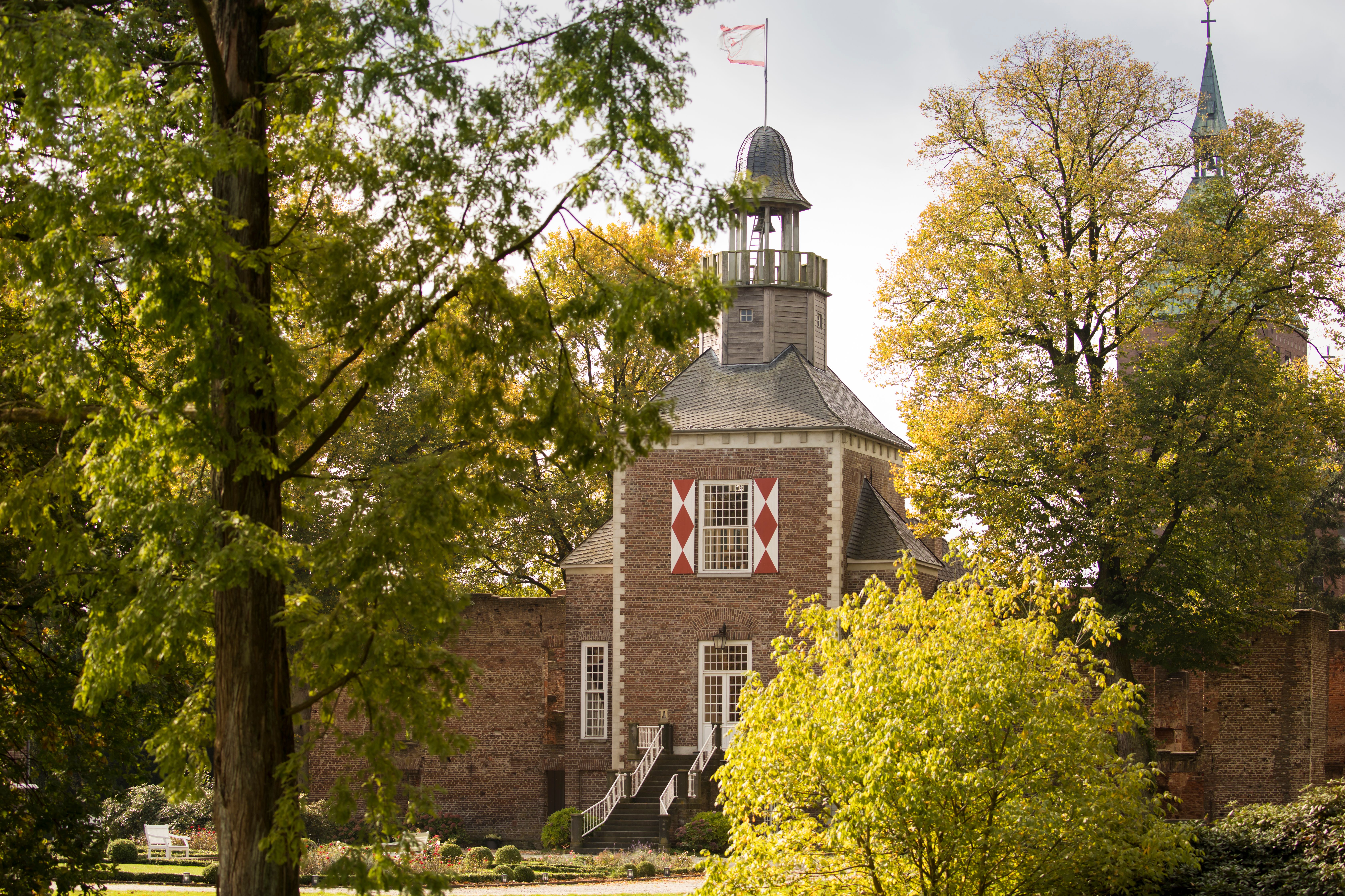 Hertefeld Castle Tower behind trees 