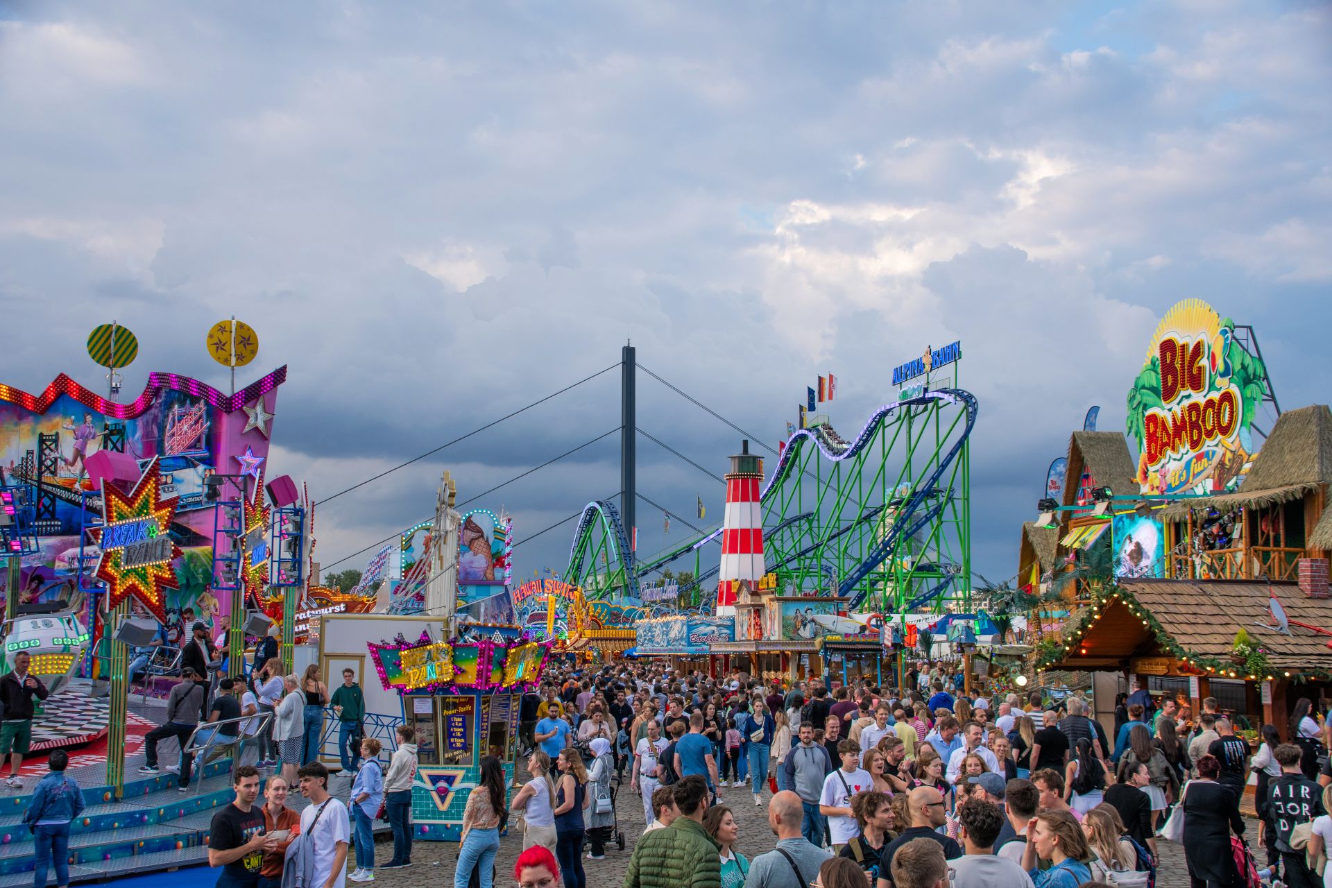 Guests drift along the promenade at the Rhine funfair in Düsseldorf